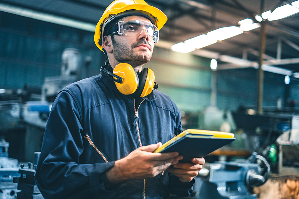 Production employee standing in plastics factory